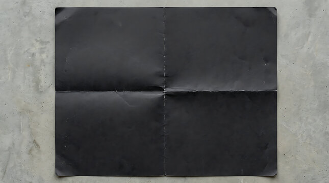 Matte black paper texture with four quadrants folded on a grey concrete background.