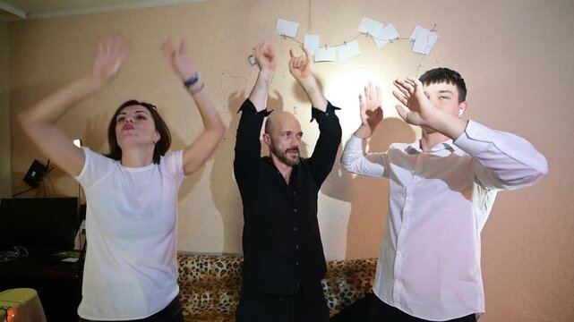 Cheerful Father and Teenage Son Having Fun and Dancing at Home Family Party