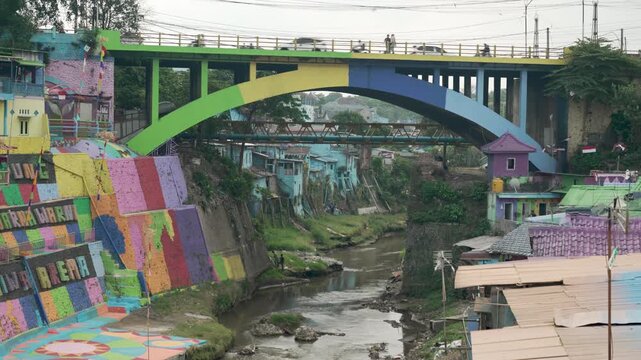 Wide view of colorful riverside houses and rainbow bridge in Malang, Indonesia