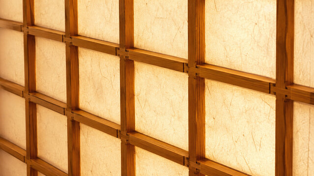 Japanese shoji screen macro showing honey-golden cedar wood kumiko lattice grid with translucent warm amber glowing washi paper cells and precise joinery detail