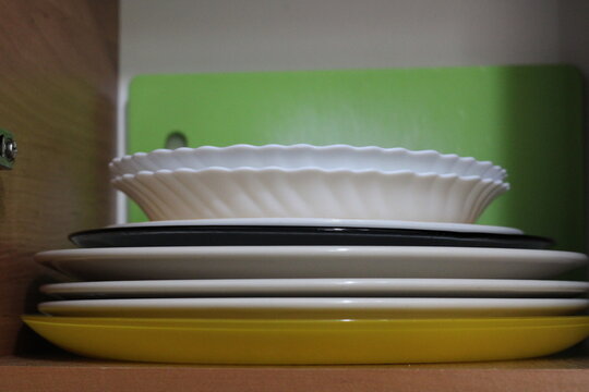 The plates are stacked on the shelf