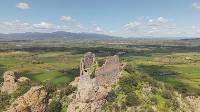 Castello di Acquafredda Medieval Fortress Near Siliqua In Southern Sardinia, Italy With Historic Stone Fortifications Over Hilltop. Aerial Shot