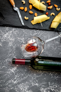 red wine with cheese on dark background top view