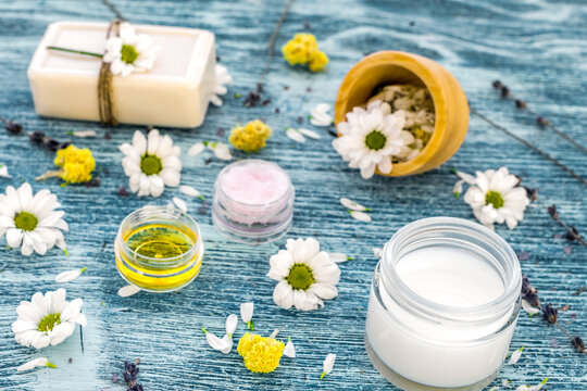 organic cosmetics with camomile on blue background