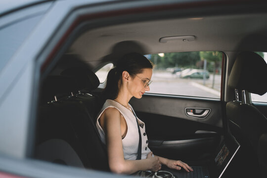 Woman working on the go with phone and laptop