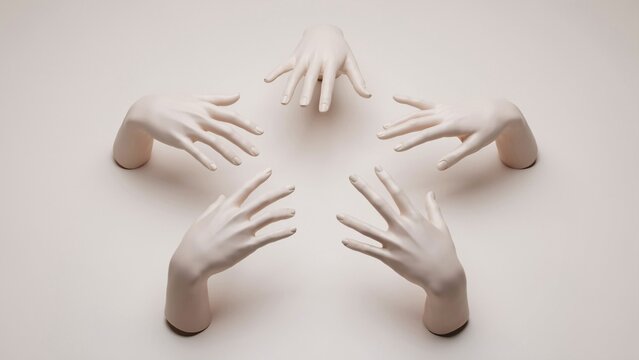 Four pale mannequin hands arranged in a circular pattern on beige background