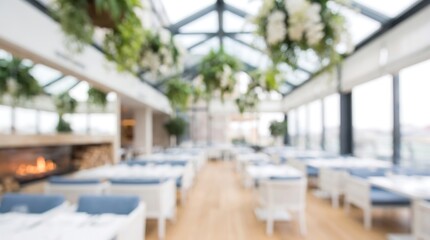 Fototapeta premium Blurred interior view of a modern high end restaurant with hanging plants and large windows creating a bright and airy dining atmosphere for a sophisticated culinary experience