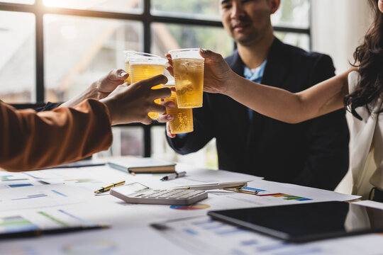 Business team clinking glasses celebrating happy hour success. Celebrate financial and business success with your partners.