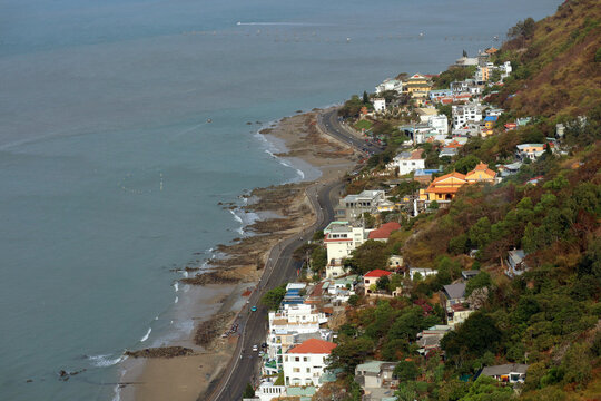 High angle view of a scenic coastal road and residential houses on a mountain side in Vung Tau.
