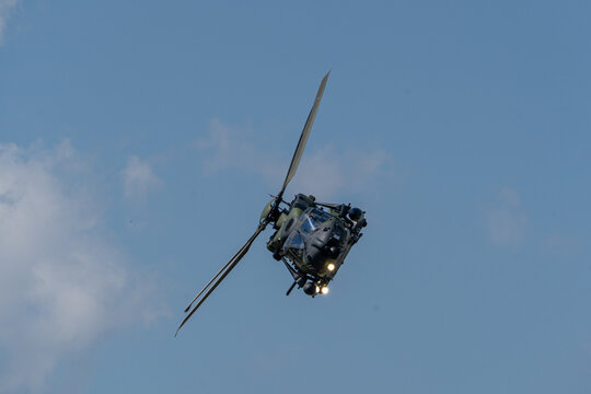 View of an NH-90 military helicopter performing a banking maneuver during the Antidotum Airshow in Leszno, Greater Poland Voivod, Poland.