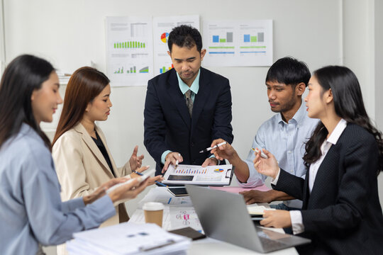 Diverse business team actively discussing and brainstorming ideas during a corporate meeting in office.