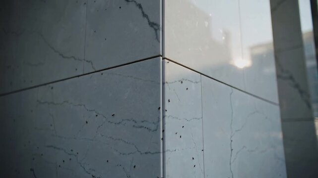Starting camera moving upward and right at stone-clad corner, revealing seam and joint details