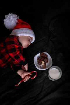 Sleeping Baby in Santa Hat with Cookies and Milk Overhead