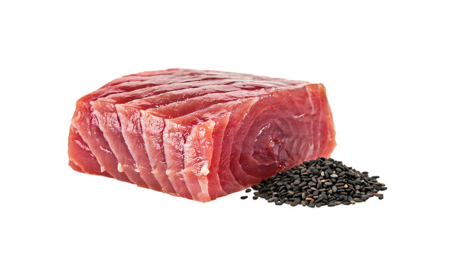 Fresh red tuna fish steak sliced into tender pieces accompanied by a small pile of crunchy black sesame seeds against a clean plain white background for culinary projects.