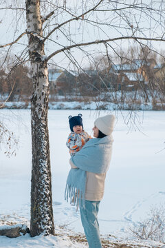 Portrait of Mother and Baby in Winter Wonderland