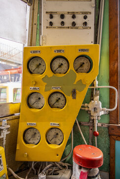 View of the vintage control panel with multiple analog gauges and yellow casing inside a train at the Railway Park in Vilnius, Vilniaus apskritis, Lithuania.
