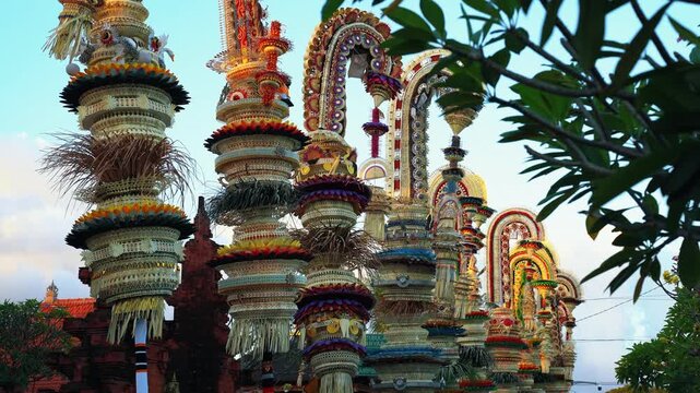 Tall decorative bamboo pole penjor erected for Galungan Hindu festival along street, Bali, Indonesia