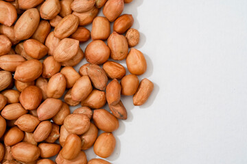 Obraz premium Raw peanut kernels in brown peel in close-up White Background