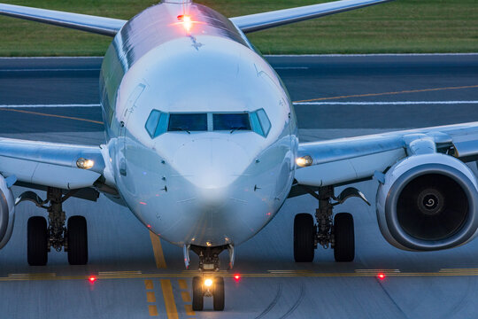 View of a commercial passenger airplane taxiing on the runway at Vilnius International Airport in Vilnius, Vilniaus apskritis, Lithuania.