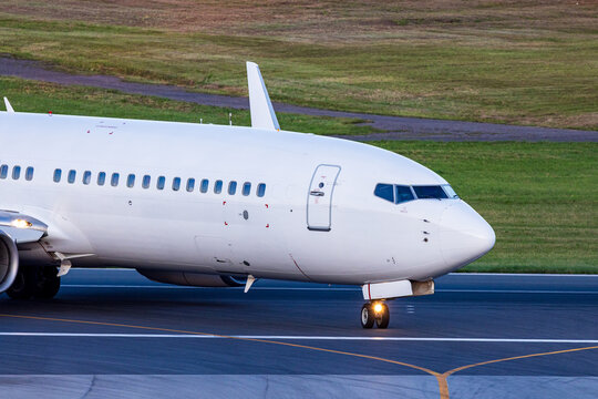 View of a white passenger airplane taxiing on the runway at Vilnius International Airport, Vilnius, Vilniaus apskritis, Lithuania.