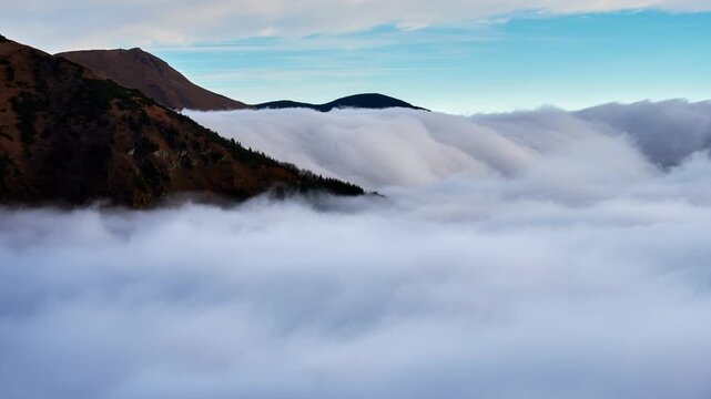 Timelapse of Fog Waterfall and Cloud Inversion Pouring Over Mountain Ridge
