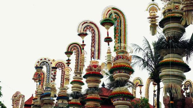 Tall decorative bamboo pole penjor erected for Galungan Hindu festival along street, Bali, Indonesia