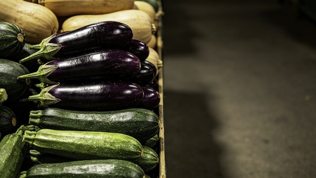 Market produce stacks with layered eggplants zucchinis and s