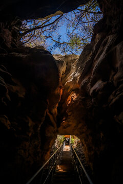 View of the rocky passage and staircase leading into the depths of French Mountain with sunlight filtering through the opening above in Antsiranana, Diana, Madagascar.