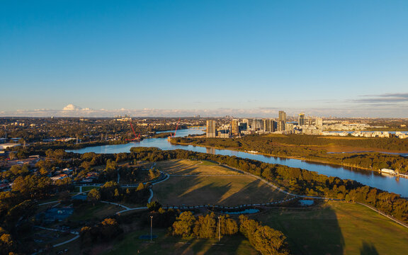 Aerial view of park, river, and apartment around Parramatta River, Sydney, Australia.