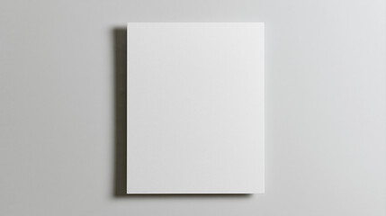 Fototapeta premium A clean 3D render mockup of a vertical blank white paper sheet or card with soft shadows on a neutral light grey background, ideal for design presentations.