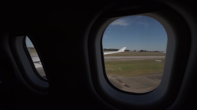 View From Airplane Window on Airport Runway Before Takeoff
