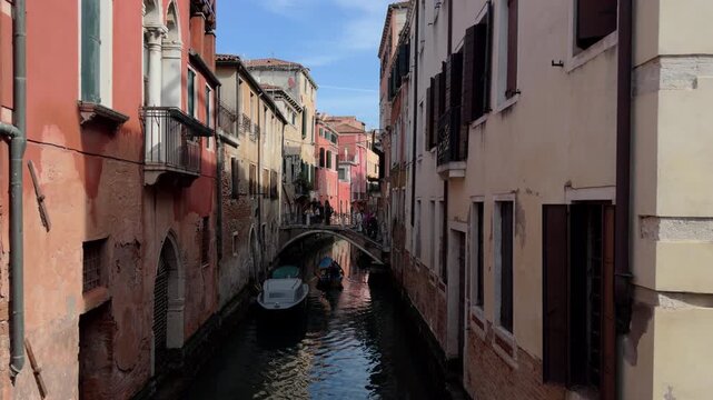 Quiet Venetian Canal with Gondola and Stone Bridge View