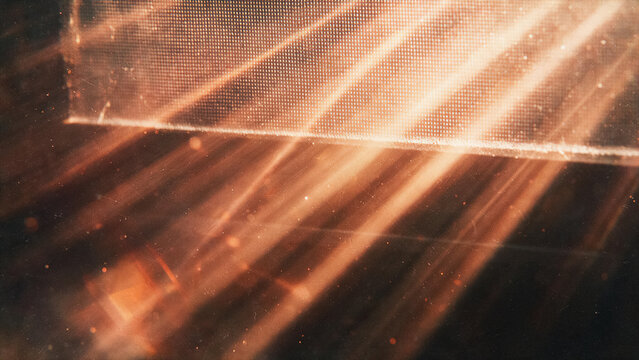 Abstract cinematic light rays with floating dust particles, light leak effect and screen texture on a dark background.