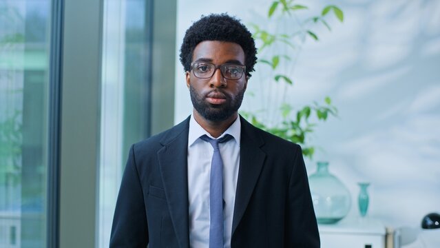 Portrait confident serious African American business man looking at camera work in marketing agency office ethnic businessman male guy manager specialist agent executive posing at corporate company