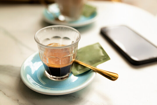 Cup of black coffee espresso on table in street cafe