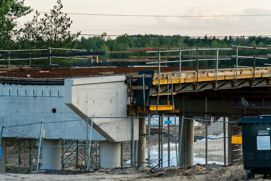 Jaworzno, Poland - 23 August 2026: View of a bridge construction site featuring concrete pillars, steel rebar, and scaffolding in the Silesian Voivodeship.