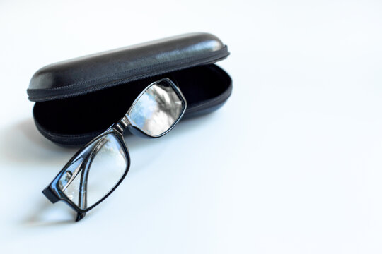 Stylish glasses for vision with case on white background. Eyesight and vision concept.