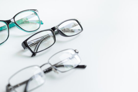 Set of glasses with different frame in optics store. Eyesight and vision concept.
