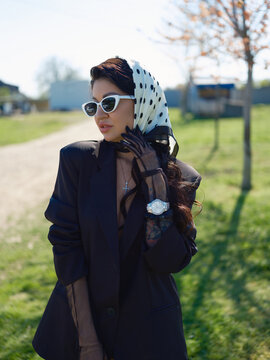 Asian woman in black blazer headscarf sunglasses outdoors portrait