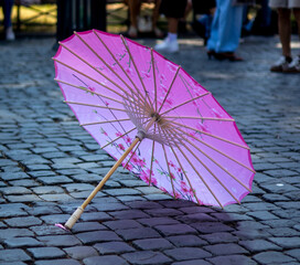 pink parasol on the street © Schnider