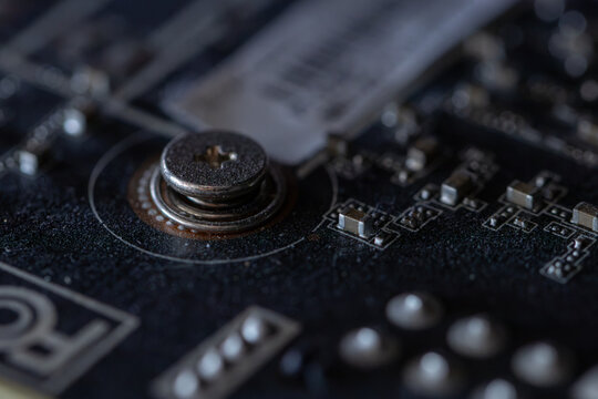 Close up screw on electronic circuit board