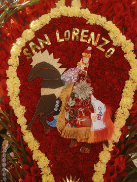 San Lorenzo, Mexico - 10 August 2026: View of an elaborate floral arrangement featuring a figure of a Moor on horseback, decorated with vibrant red and yellow flowers for a traditional festival.