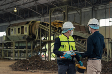 Fototapeta premium Engineers inspecting thermal waste treatment process inside waste management recycling factory.