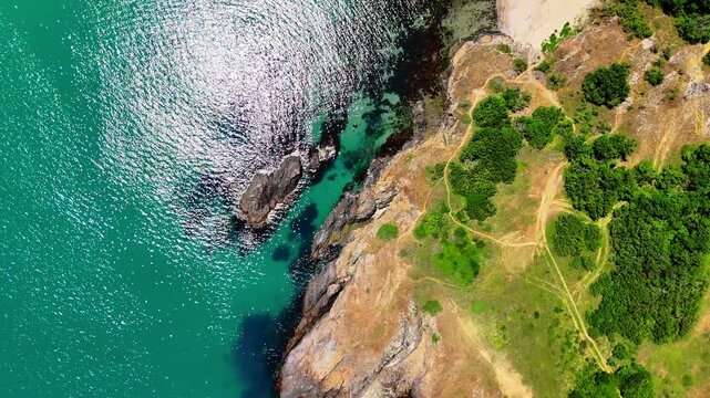 Wide aerial view of a secluded sandy beach with clear turquoise water, rocky shoreline and dense green vegetation along Bulgaria&rsquo;s southern Black Sea coast.
