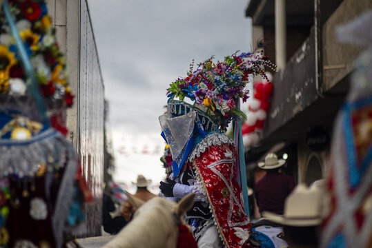 Angahuan, Michoacan, Mexico - 25 July 2024: View of traditional Moros dancers wearing elaborate floral headdresses and ornate costumes during a local festival celebration.