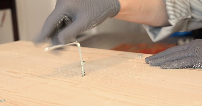 A man assembling a wooden bookshelf