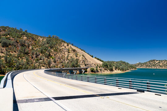 A scenic view of the Moccasin Creek Bridge curving over Don Pedro Reservoir in California