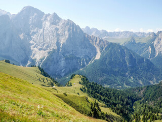 Fototapeta premium the Dolomites rocky cliffs, as seen from the high-altitude green meadows near the famous Viel dal Pan Trail.