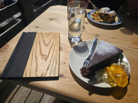 Sacher torte dessert on open air alpine environment in dolomites