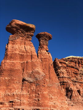 Low angle view of rock formation against clear blue sky